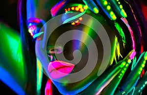 Fashion model woman in neon light. Beautiful model girl with colorful fluorescent makeup