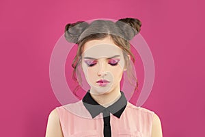 Fashion model woman with pink eyeshadow makeup on pink background