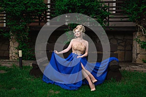 Fashion model woman posing sexy, wearing long evening dress