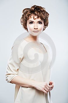 Fashion model woman posing in studio. Young model with short ha