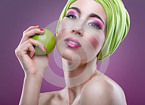 Fashion modell with beautiful pink makeup and green apple photo