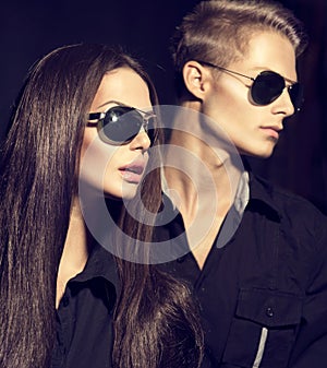 Fashion models couple wearing sunglasses