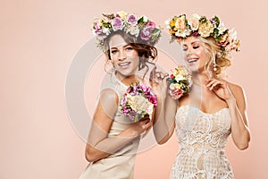 Fashion Models Flowers Hairstyle Beauty Portrait, Two Happy Women with Flower Wreath and Bouquet