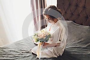 Fashion Models Portrait with Flower Bouquet, Beautiful Woman Bride Makeup and Hairstyle, Girl studio shot on gray