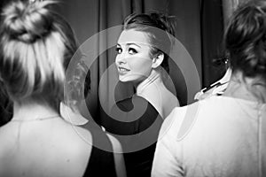 Fashion models prepared for runway by stylish designer. Black and white photography