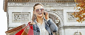 Fashion-monger near Arc de Triomphe using mobile phone, Paris