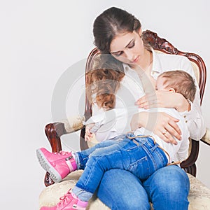 Fashion mother breast feeding a cute baby. Newborn girl.