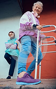 Fashion, old women and friends portrait in city on blue and red wall with stylish vintage jacket and designer shoes low