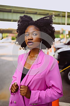 Fashion outdoor street style portrait of Beautiful young African American woman posing outside on urban city landscape