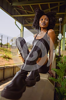 Fashion outdoor street style portrait Beautiful young African American woman posing outside on urban city landscape