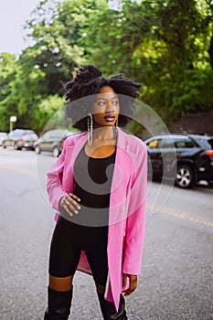 Fashion outdoor street style portrait of Beautiful young African American woman posing outside on urban city landscape