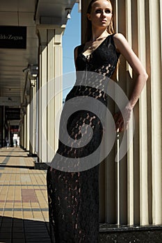 Fashion outdoors portrait of beautiful woman model in luxury black lacy dress
