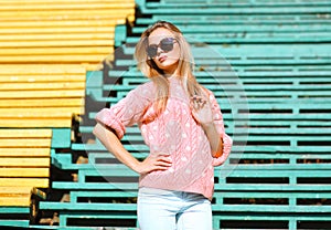 Fashion and people concept - pretty blonde in sunglasses posing