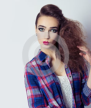 Fashion photo of a beautiful girl with red lips, big eyes, bright makeup and stylish hair salon