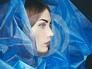 Fashion photo of beautiful women under blue veil