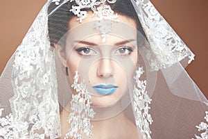 Fashion photo of beautiful women under white veil