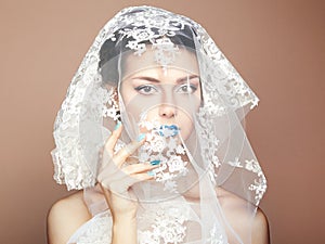 Fashion photo of beautiful women under white veil