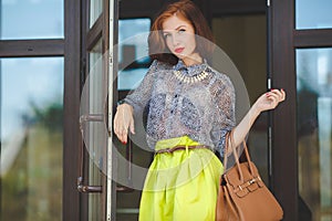 Fashion photo of beautiful young woman with bag.