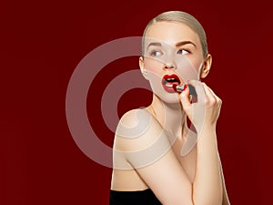 Fashion photo. Closeup of woman face with bright red matte lipstick on full lips. Beauty Cosmetics, Makeup Concept. A