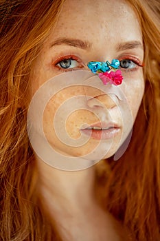 Fashion photo woman extended fake eyelashes for red haired with rose flower face