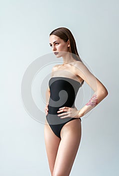 Fashion photo of woman posing in black swimsuit