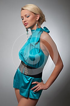 Fashion photo of a woman in short cyan dress