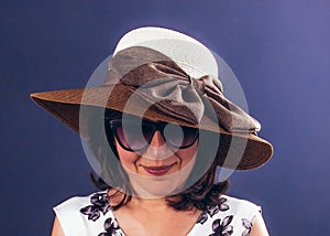 Fashion photo of young beautiful lady in hat and sunglasses. Summer beach travel, holiday