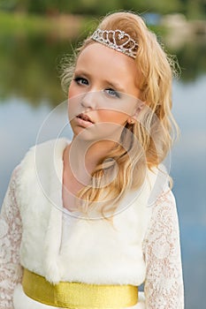 Fashion photo of a young girl in a beautiful white dress