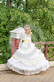 Fashion photo of a young girl in a beautiful white dress