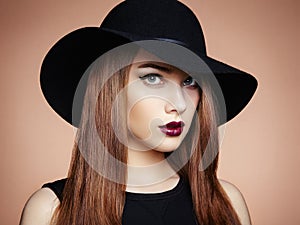 Fashion photo of young magnificent woman in hat. Girl posing