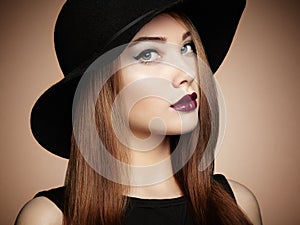 Fashion photo of young magnificent woman in hat. Girl posing