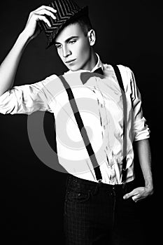 Fashion photo of young model man on black background. Boy posing. Studio photo. Black and white