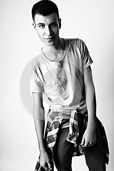 Fashion photo of young model man on white background. Boy posing. Studio photo. Black and white