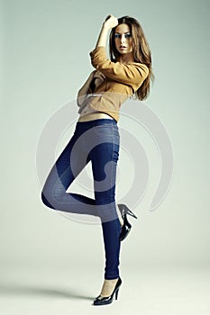 Fashion photo of young sensual woman in jeans