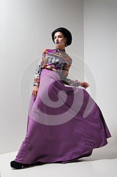 Fashion photo of young woman in purple dress