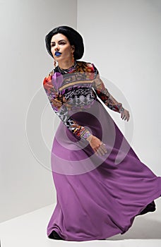 Fashion photo of young woman in purple dress