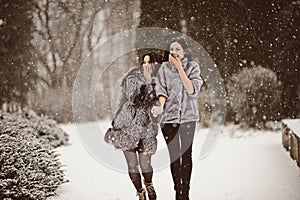 fashion photo of young women in winter landscape