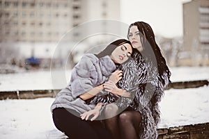 fashion photo of young women in winter landscape