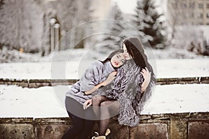 fashion photo of young women in winter landscape