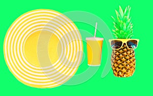 Fashion pineapple with sunglasses and yellow straw beach hat cup