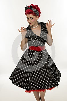 Fashion pinup girl in black polka dots dress.Vintage