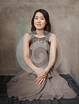 Fashion, portrait and asian woman with dress on a floor for elegance, beauty or chic clothes on wall background. Stylish