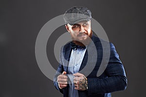 Fashion Portrait of bearded man in suit.old Hipster boy.handsome man in hat.Brutal