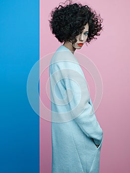 Fashion portrait of beautiful asian woman in sky-blue coat