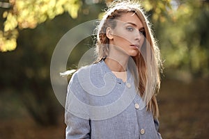 Fashion portrait of beautiful blonde woman in stylish clothes outdoor in autumn.