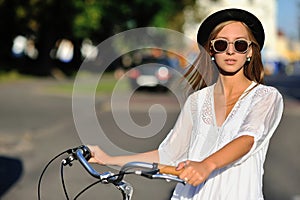 Fashion portrait of beautiful girl with bike