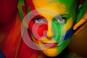 Fashion portrait of beautiful girl with bright,colorful, creative art make-up, abstract face art on colors background