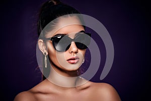 fashion portrait of beautiful Indian woman who wearing sunglasses and earrings. Asian glamour