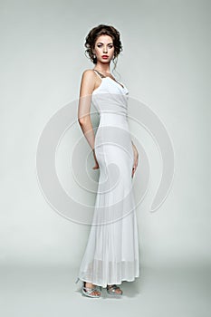Fashion portrait of beautiful woman in elegant dress