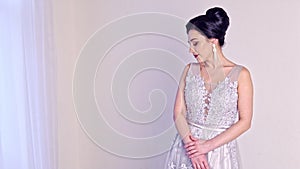 Fashion portrait of beautiful woman in elegant white dress.